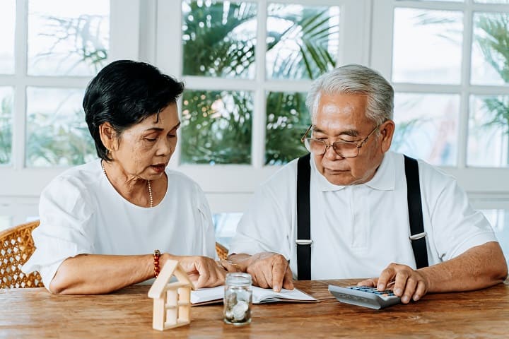 Asian elderly couple calculating the cost of HD therapy